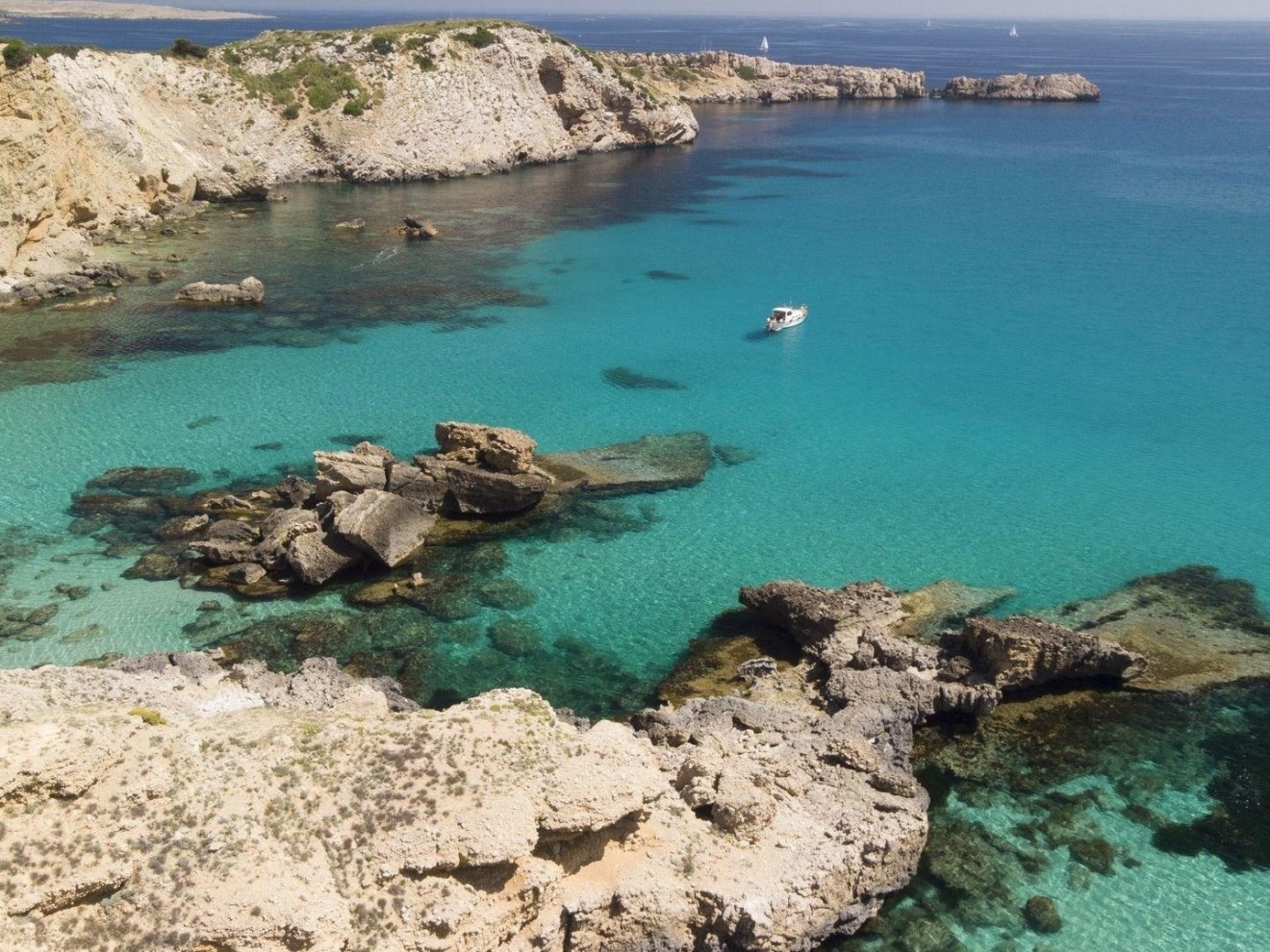 a rocky beach next to a body of water