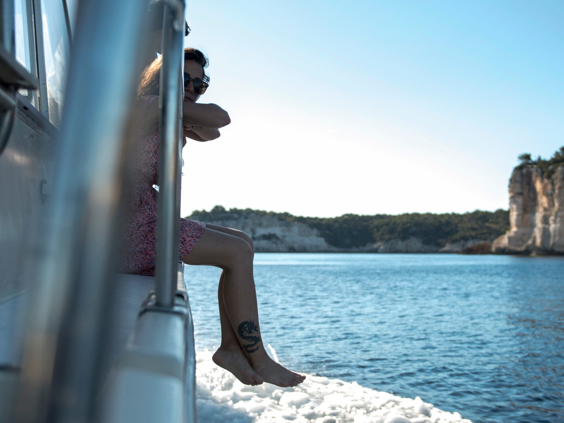 a person sitting on the side of the water